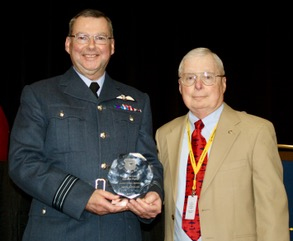 Squadron Leader Gordon Parry receiving his award from the Aerial Refuelling Systems Advisory Group Chief Operating Officer, Lt Gen John Sams, Chief Executive Officer and Chairman for ARSAG.